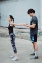 Young Man and Girl Doing Arm Stretching Exercise