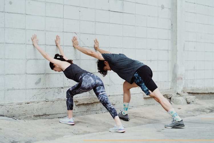 People In Sportswear Exercising Outdoors