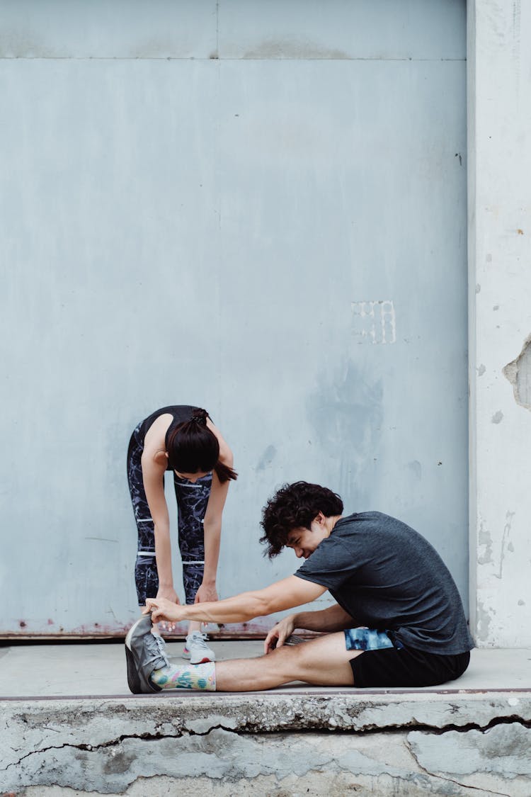 Man And Woman Exercise Bends Together