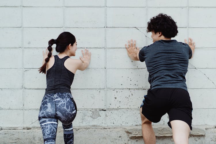 Back View Of Happy Athletes Exercising Outside