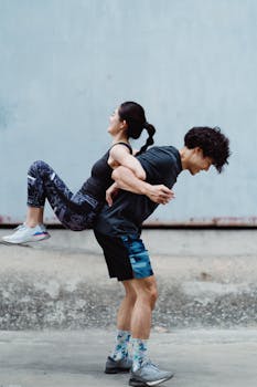 Pair of athletes exercising together outdoors, showcasing strength and teamwork.