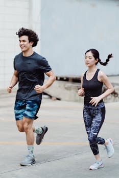 Asian couple jogging together outdoors, promoting healthy lifestyle and fitness.