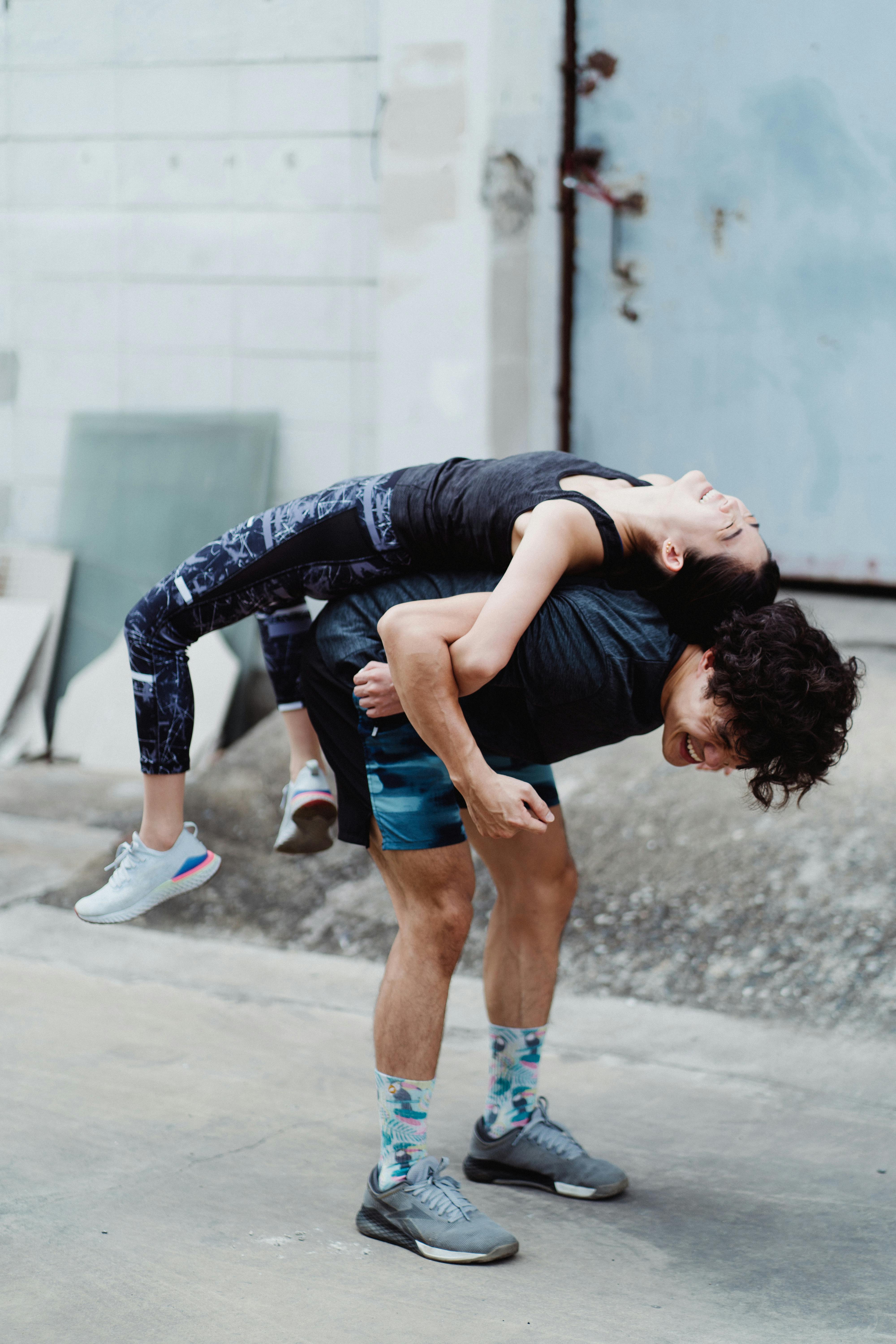 Smiling Young Couple Training Outside Together · Free Stock Photo
