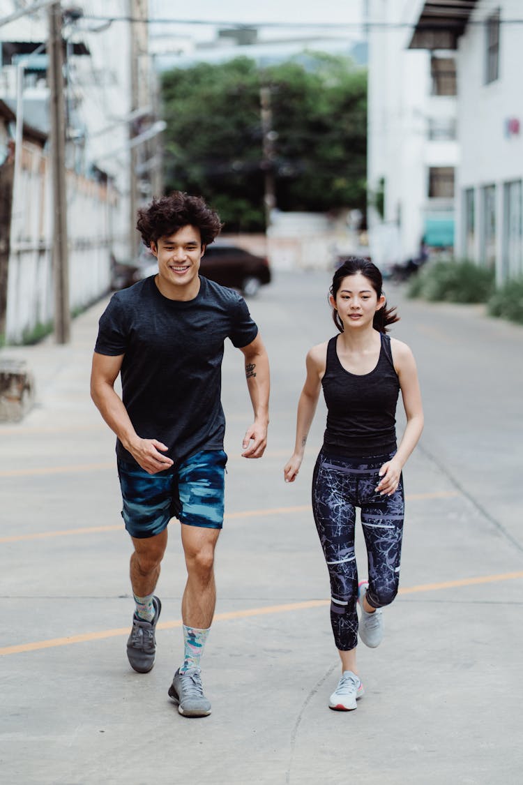 Man And Woman Running In City