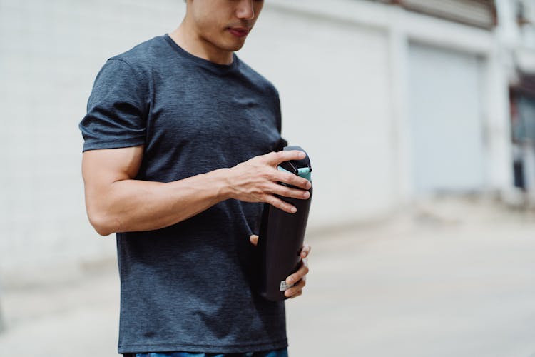 Man Holding Sport Water Bottle