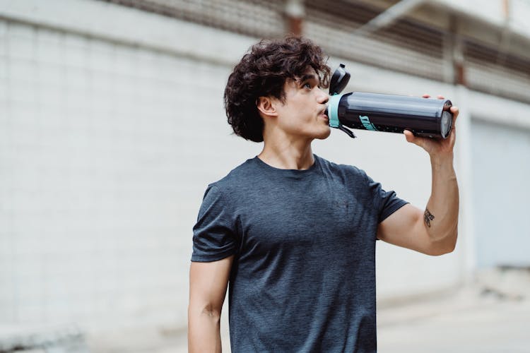 
A Man Drinking From A Tumbler