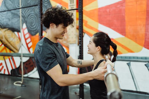 A young couple working out together in a colorful gym environment.