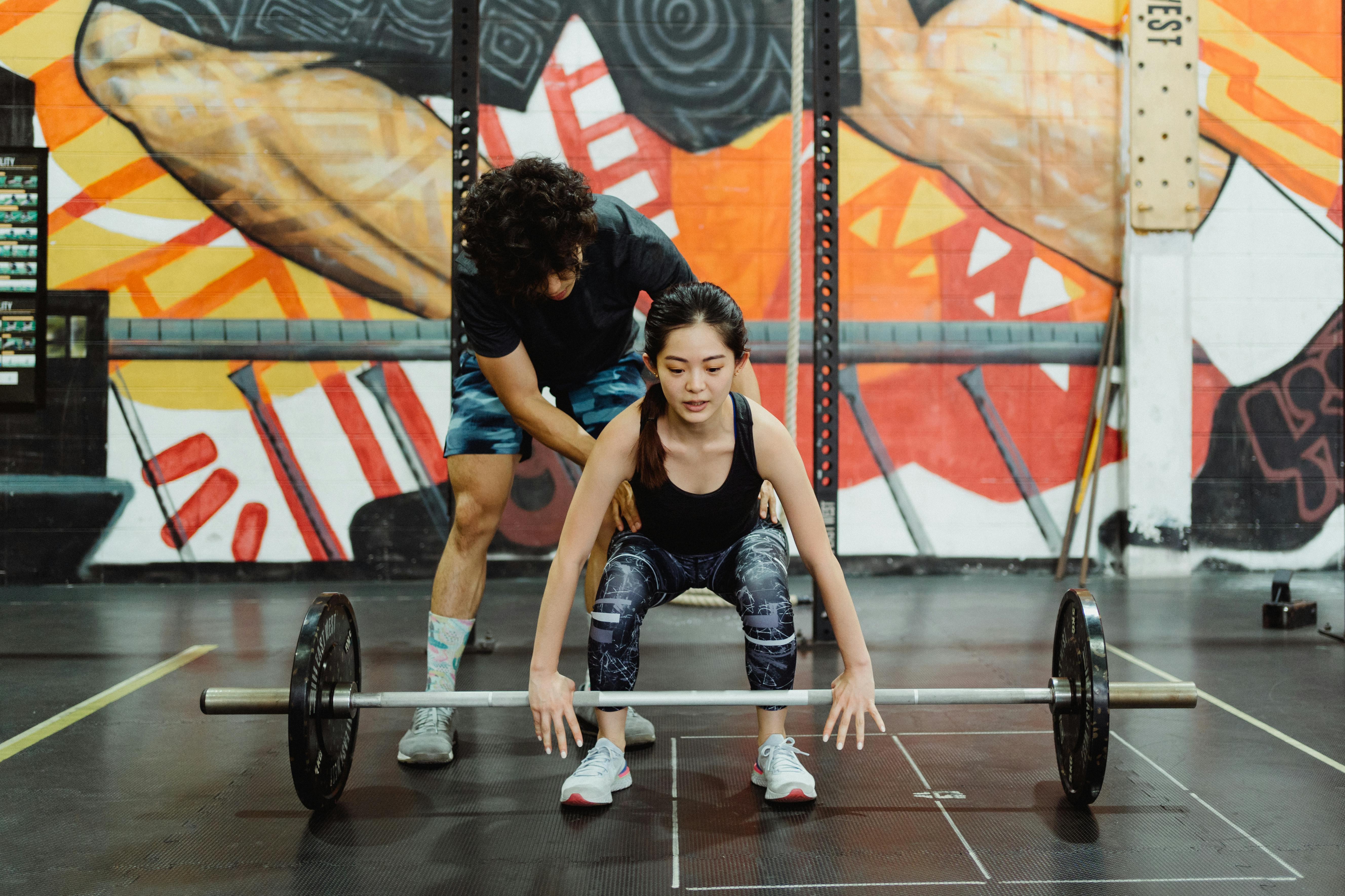 man and woman exercise together with weights