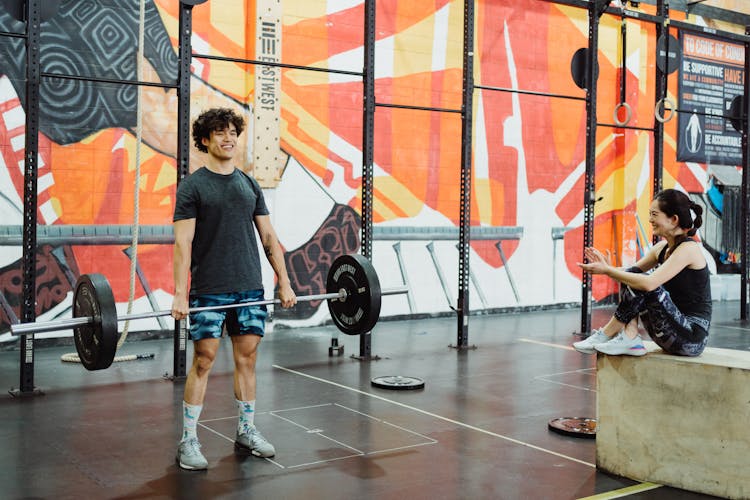 Woman Cheering Man During Weightlifting