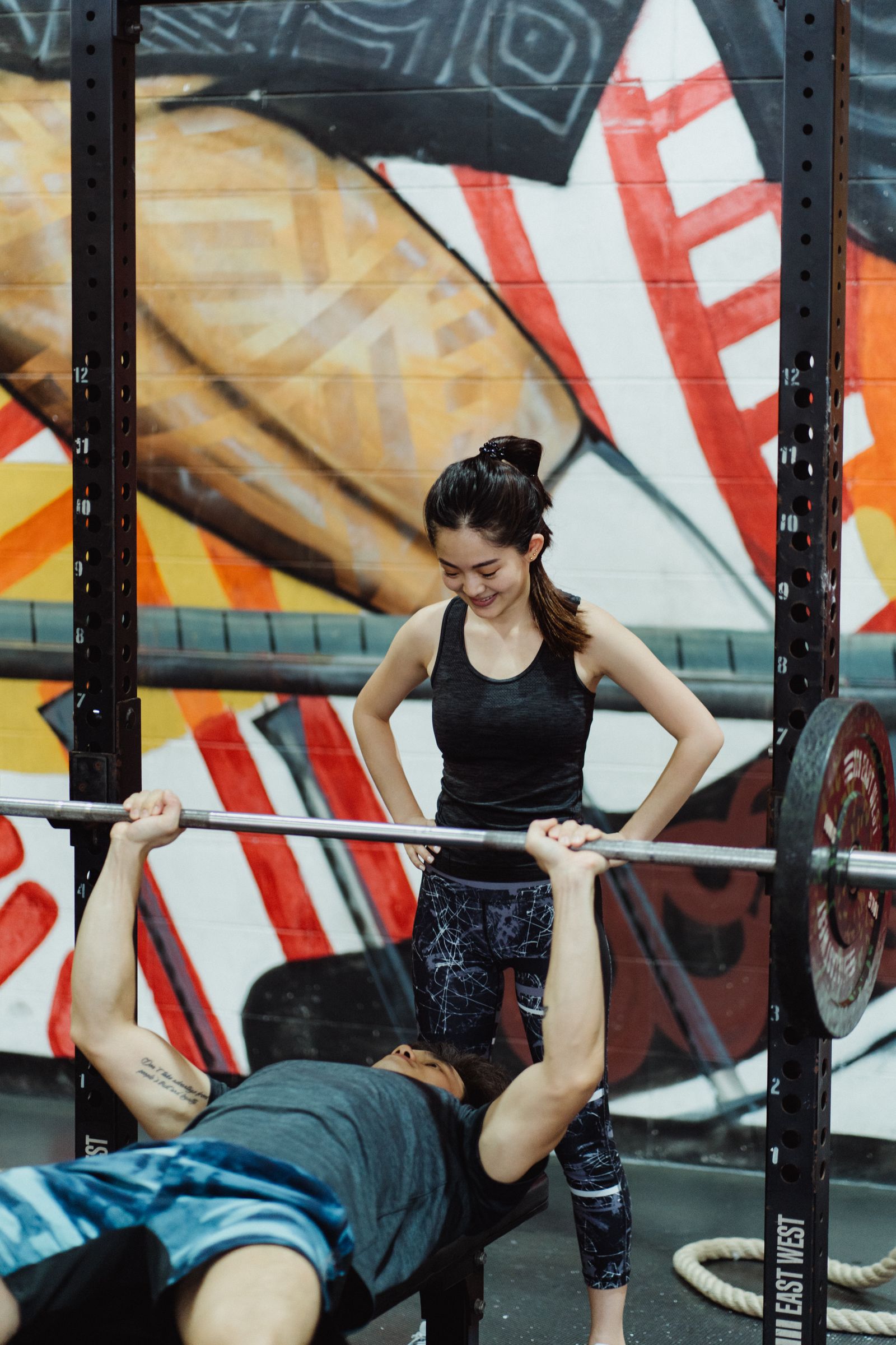 Athlete performing a bench press with a training partner