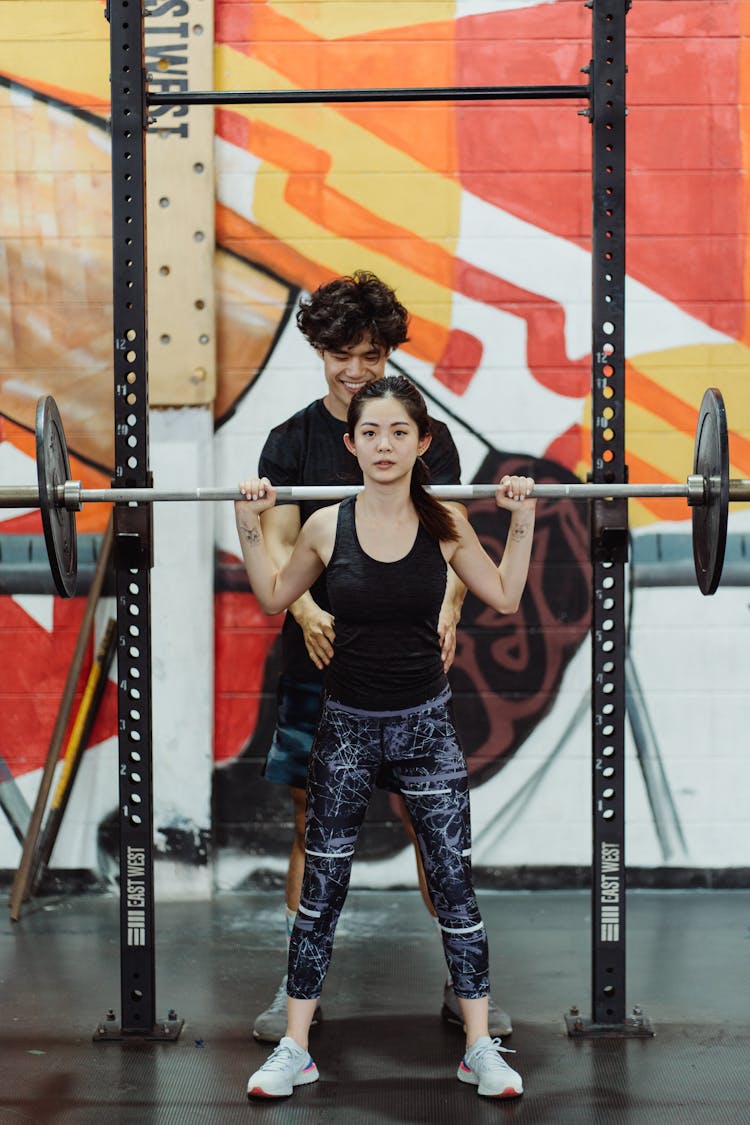 Woman Lighting Weights At The Gym