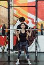 Woman Weightlifting with Help From Trainer