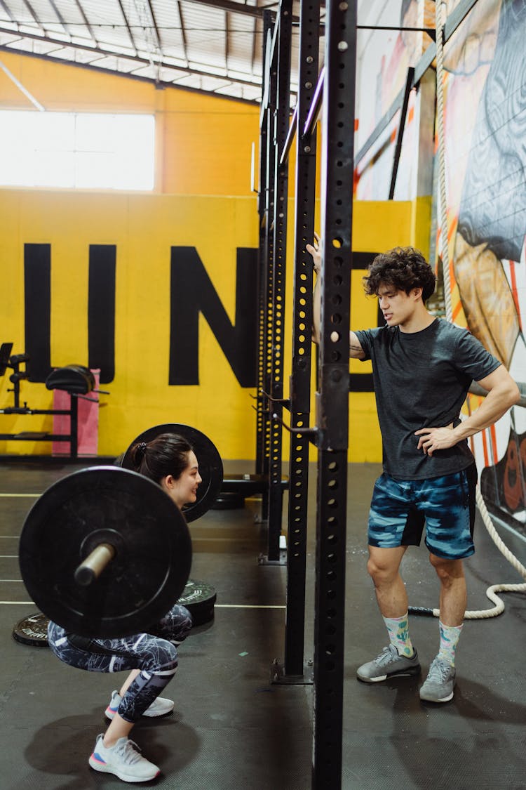 A Woman Doing A Barbell Squat