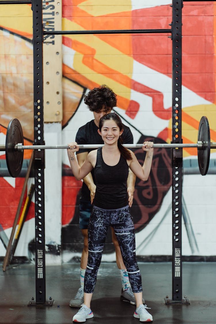 Smiling Woman Lifting Weights