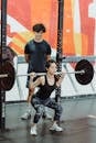 A Woman Lifting a Barbell with Weight Plates