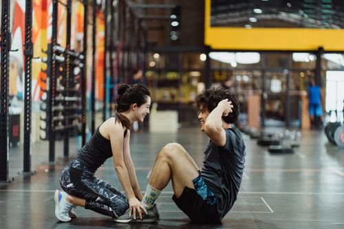 Free Asian couple enjoys fitness routine together in a gym, promoting healthy lifestyle and partnership. Stock Photo