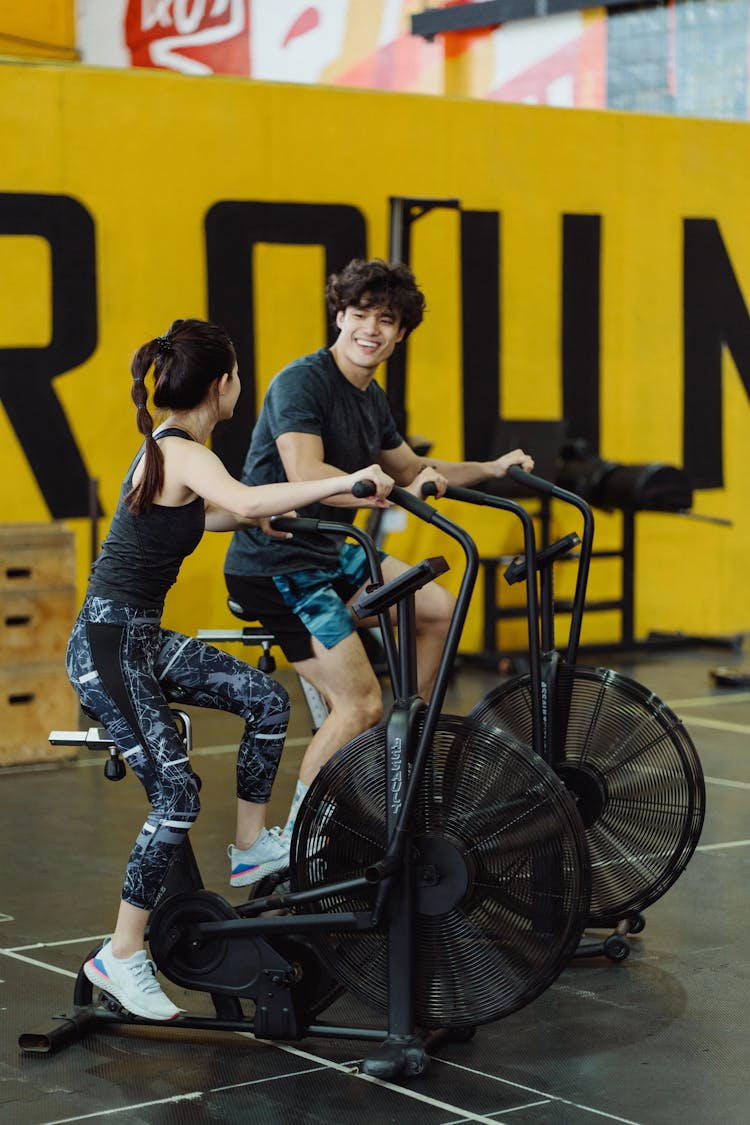 A Couple Using Elliptical Trainers