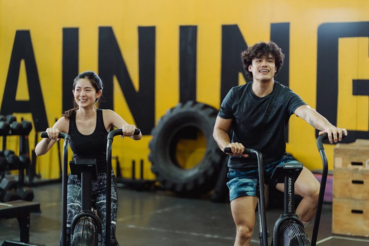 A Couple Using Elliptical Trainers