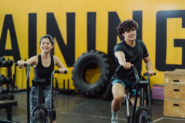 A Couple Using Elliptical Trainers