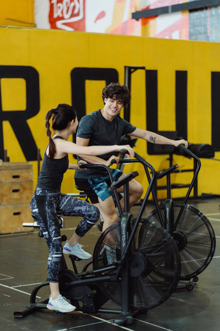 A Couple Using Elliptical Trainers