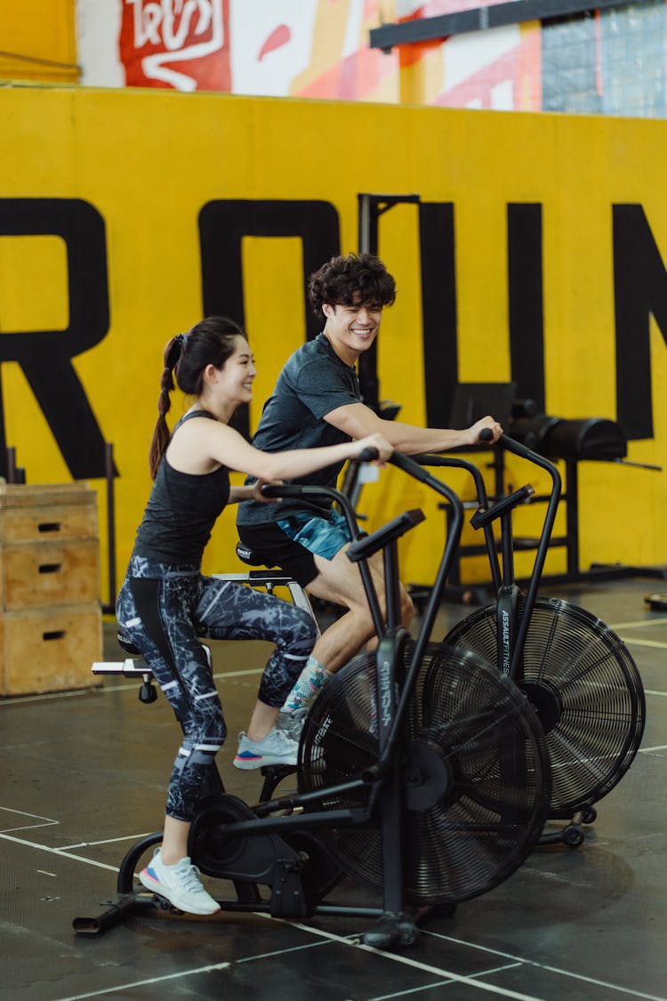 A Couple Using Elliptical Trainers