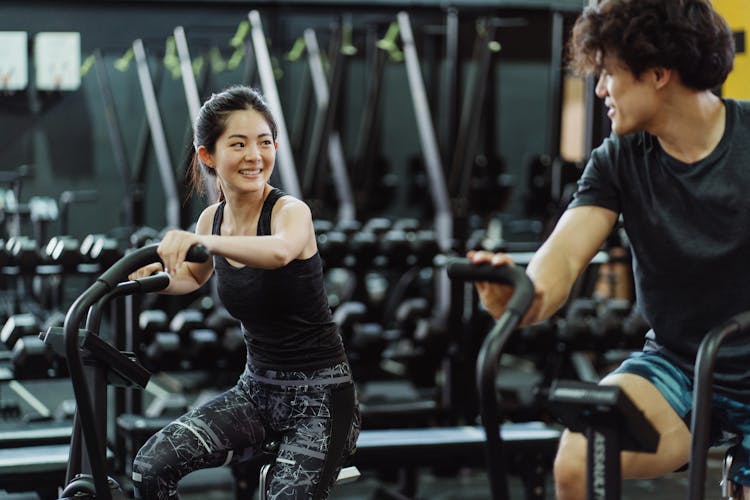 A Couple Using Elliptical Trainers