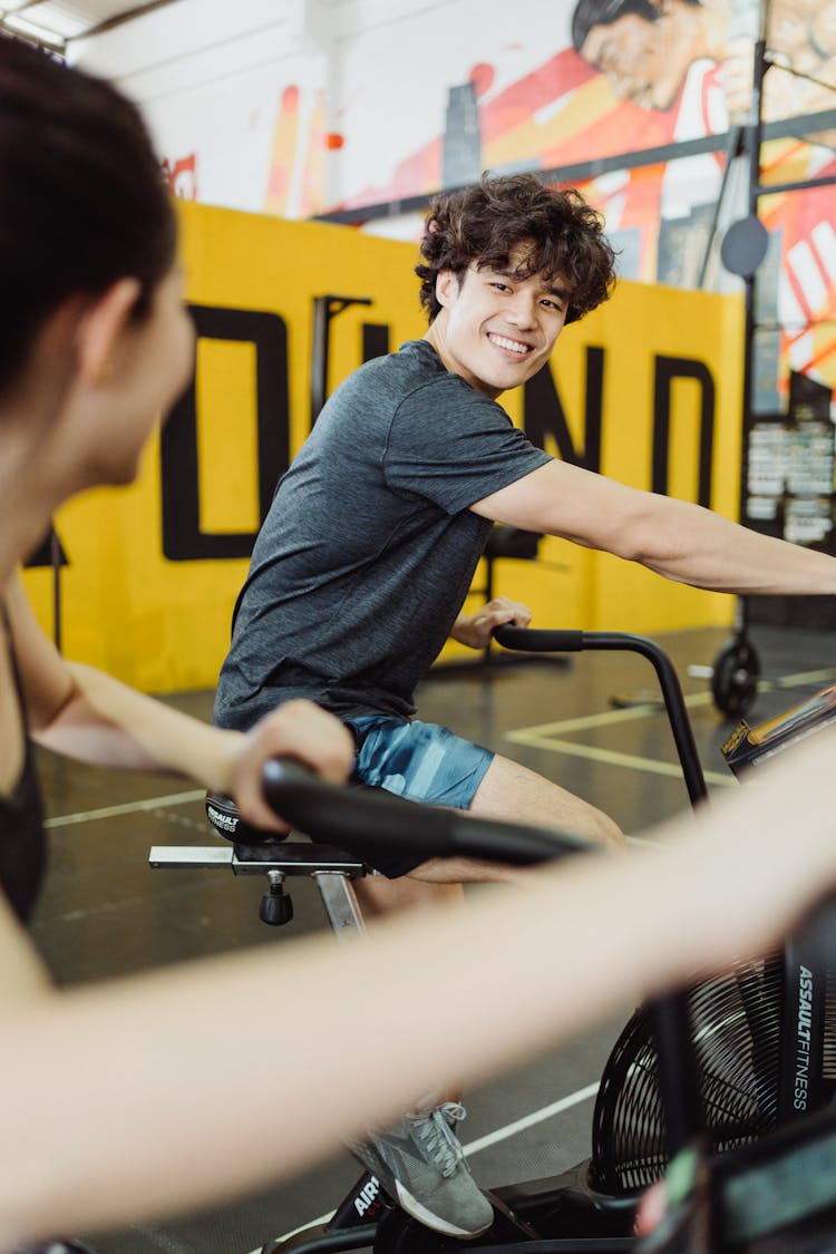 A Man Using An Elliptical Trainer 