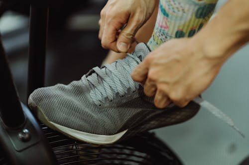 A Person Tying the Shoelace