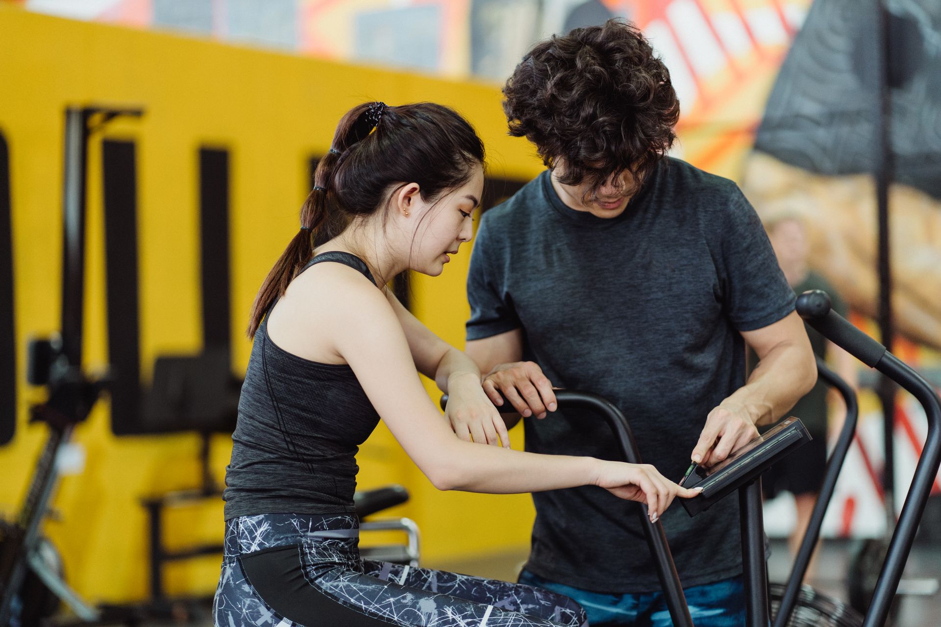 A Couple Setting Up an Elliptical Trainer