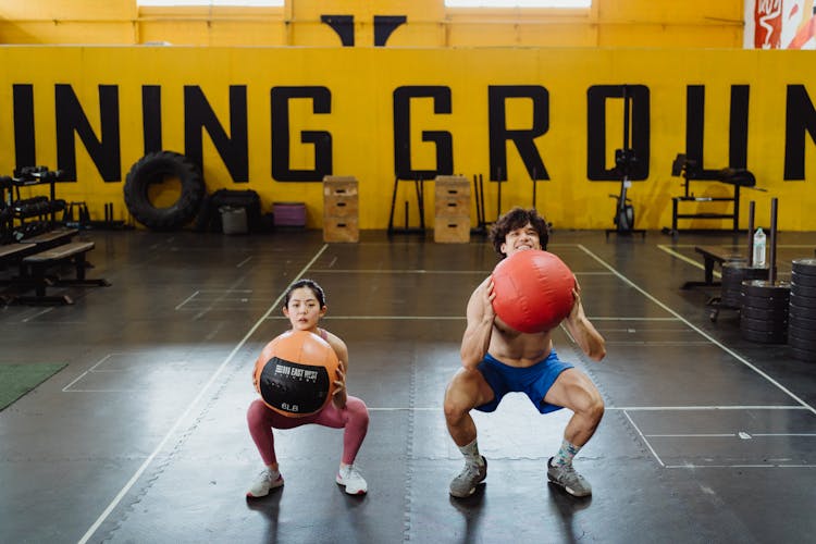 A Couple Working Out With Medicine Balls