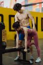 Man in Blue Tank Top and Purple Sweatpants Doing Push Up