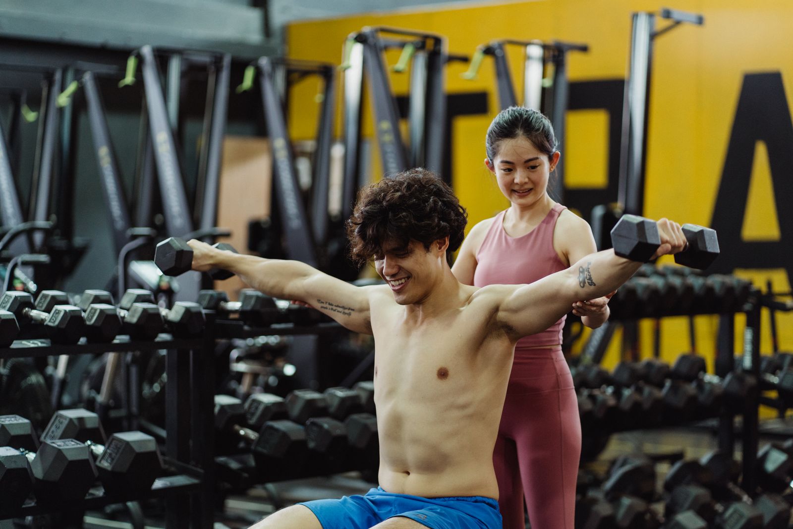 Athletes training together with dumbbells in a functional gym