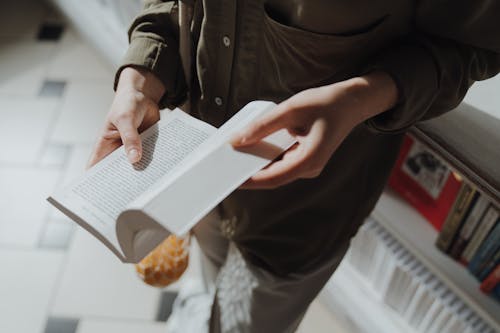 Persona In Giacca Nera Che Tiene Libro Bianco