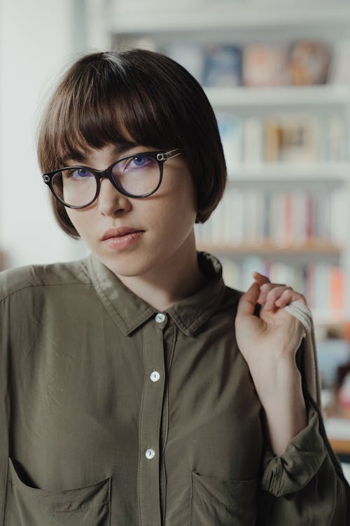 Woman in Gray Button Up Shirt Wearing Black Framed Eyeglasses