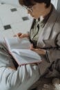 Man in Black and White Checkered Dress Shirt Reading Book