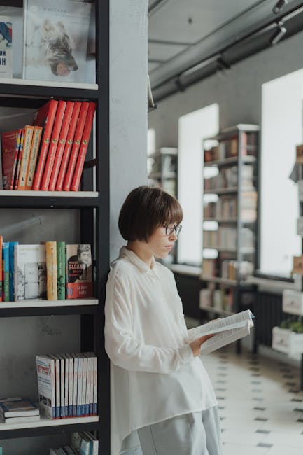 Woman in Green Sweater Lying on Black Leather Couch · Free Stock Photo
