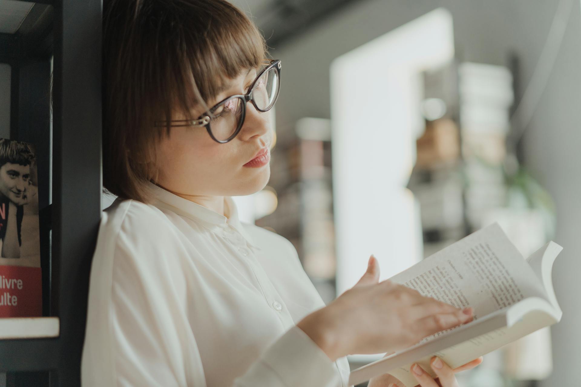 Woman in White Dress Shirt Wearing Eyeglasses Reading Book