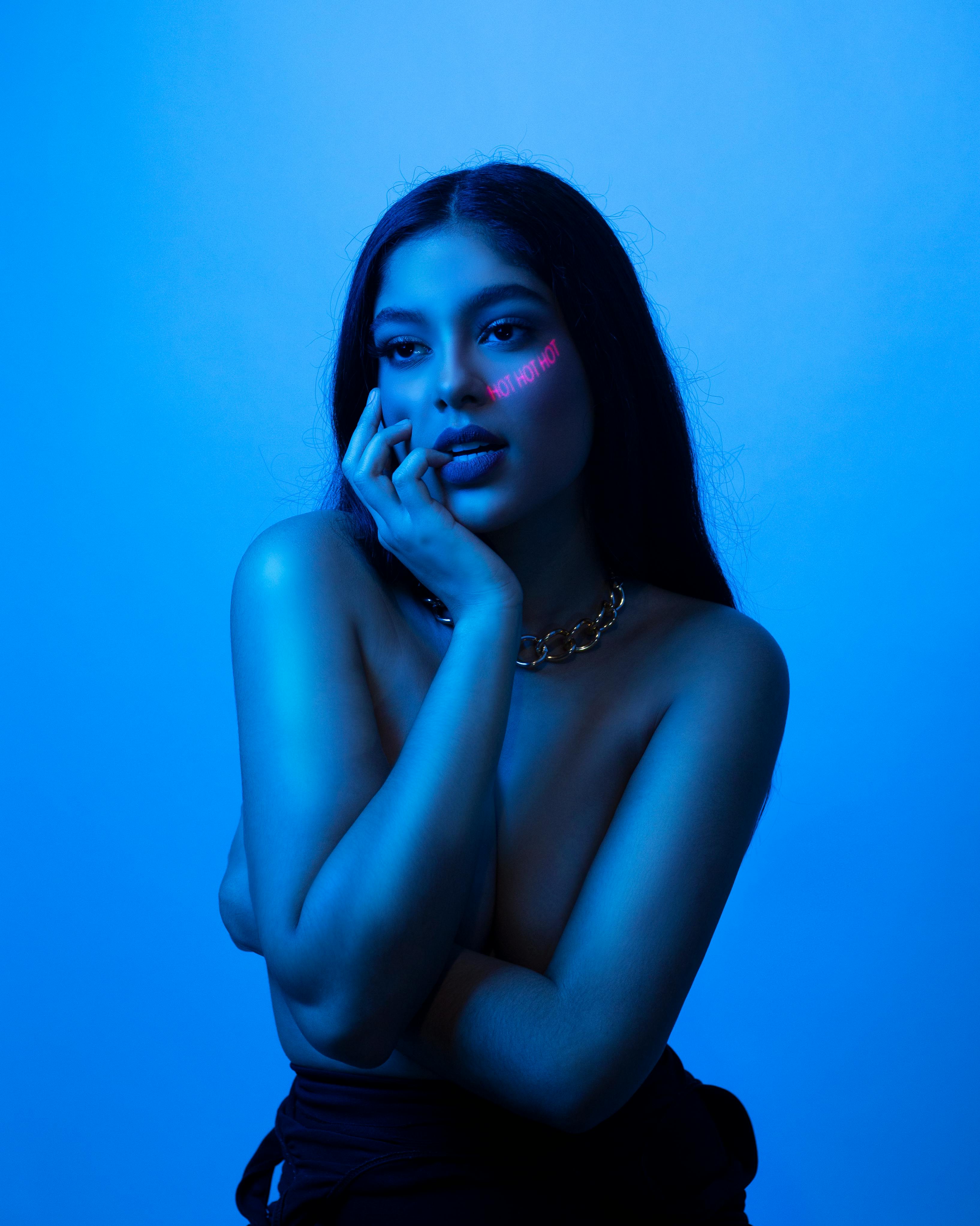 topless woman in dark blue illumination