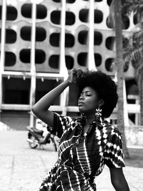 A Grayscale Photo of a Woman with Her Hand on Her Hair