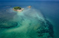 Small tropical island in blue ocean