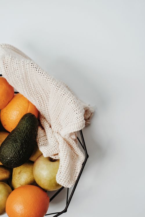Free Aerial view of assorted fresh fruits in a reusable basket with a burlap cloth promoting sustainable shopping. Stock Photo