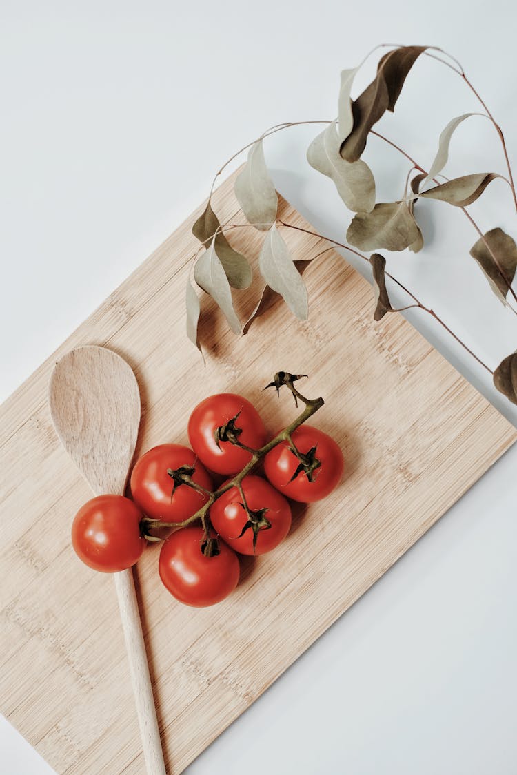 Red Tomatoes On Brown Wooden Chopping Board