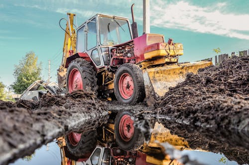 Bulldozer Reflecting in Puddle