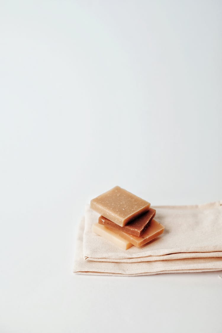 Stack Of Natural Soap Bars On Linen Cloths