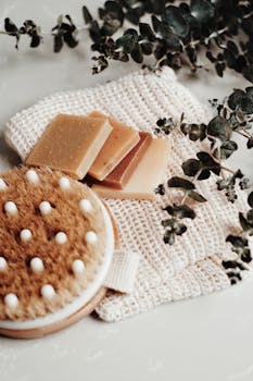 High-quality handmade soap with a body brush and eucalyptus leaves for an eco-friendly bath setup.