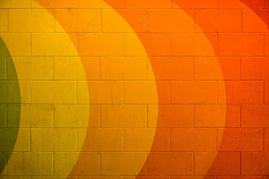 Textured background of aged shabby wall with multicolored paints representing LGBTQ in daylight