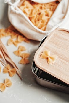 Close-up of bow-tie pasta on a wooden board, ideal for Italian cuisine visuals.