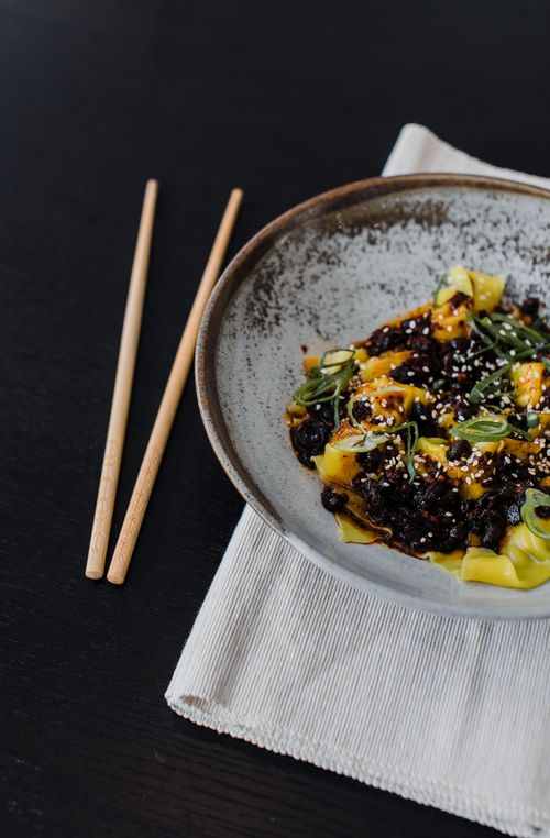 Free High angle of Asian meal in bowl placed on table near wooden chopsticks in cafe Stock Photo