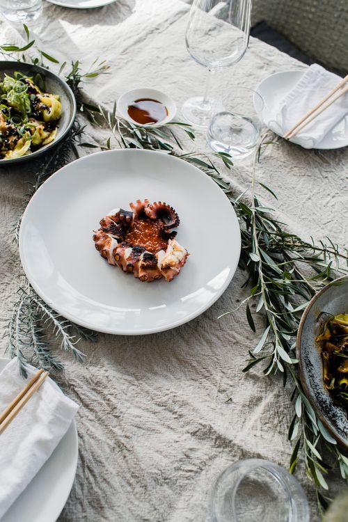 Free From above of table served with appetizing dishes on ceramic plates and empty glasses Stock Photo