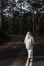 秋日，一名女子在宁静的林间小路上漫步，拥抱孤独与自然